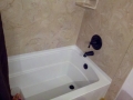 acrylic tub with culturaled marble surround.jpg